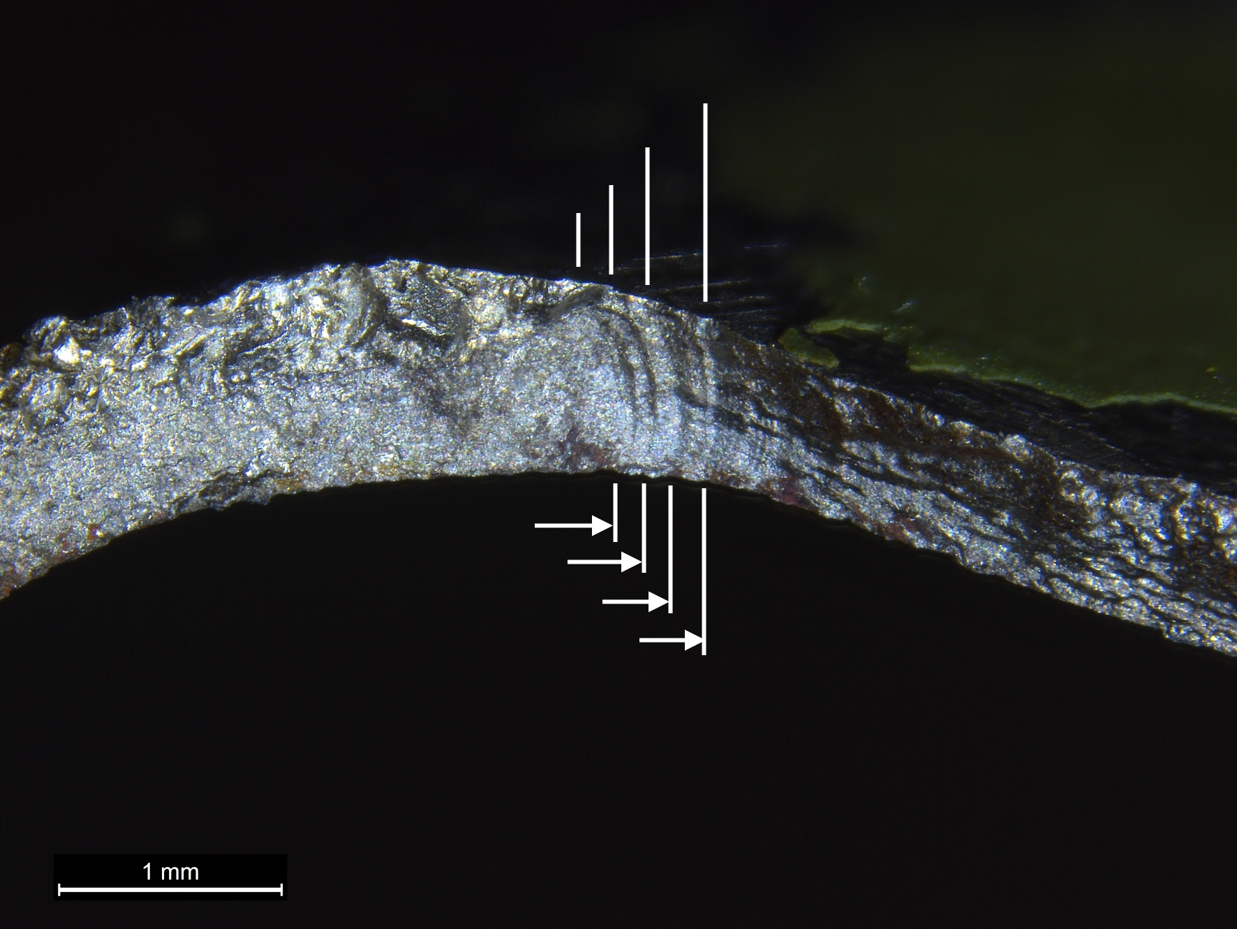 Figure A5: High magnification view of a portion of the stabiliser mount fracture surface with clearly defined fatigue progression bands (arrowed)